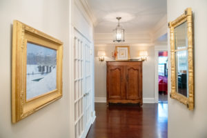 Front hall with French armoire, Picasso lithograph, Dunlay oil painting, and a peek at the 'red room'